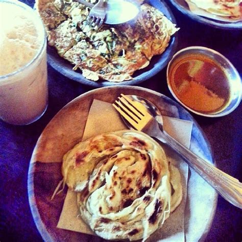 Roti canai with dial curry and teh tarik drink photos. Roti Canai & Teh Tarik Bunana - Indian Restaurant