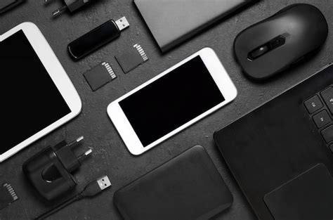 Premium Photo Electronic Gadgets On A Black Concrete Background