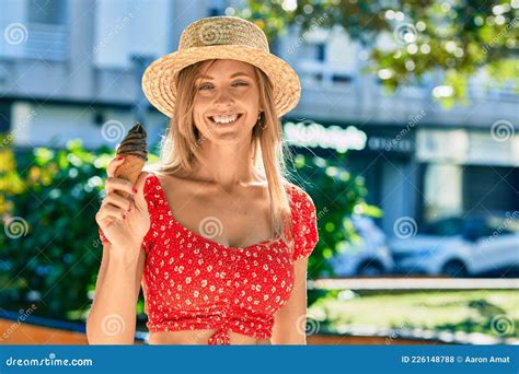Young Blonde Tourist Woman Wearing Summer Style Eating Ice Cream At The