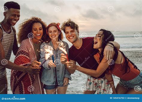 Friends Partying On The Beach With Sparklers Stock Image Image Of