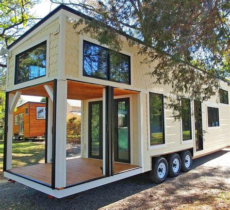 This Farmhouse Style Tiny Home Has Its Own Built In Porch Area