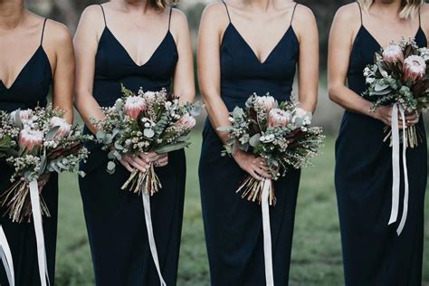 Bridesmaids In Black Dresses With Protea Bouquets Velvet Bridesmaid