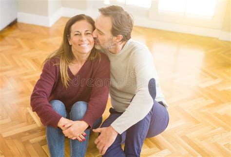 Beautiful Romantic Couple Sitting Together On The Floor At Home Stock