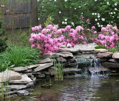 Bright Pink Flowers On An Artificial Waterfall Pond Landscaping