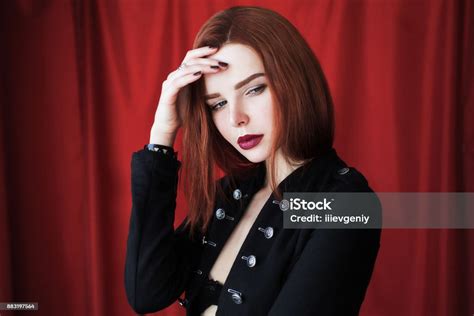 Beautiful Redhaired Girl In Black Unbuttoned Jacket With Red Lips On