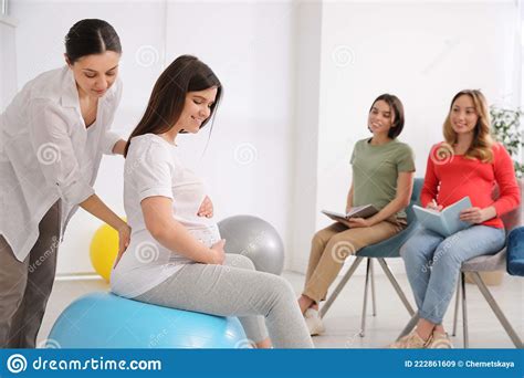 Group Of Pregnant Women With Midwife At Courses For Expectant Mothers Indoors Stock Image
