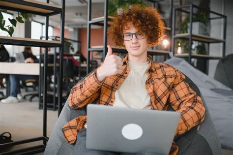 Great News Male Teenager Expressing Success In Front Of Laptop At Cafe Clenching His Fist And