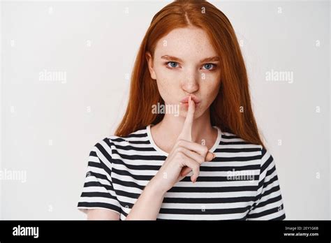Close Up Of Young Ginger Girl With Serious Face Showing Taboo Sign
