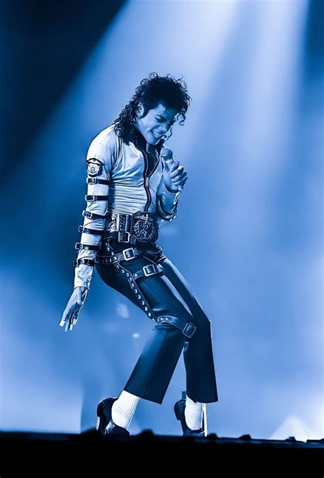 Michael Jackson Performing On Stage With His Hands In The Air And