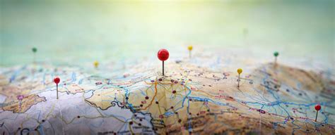 Pins On A Geographic Map Curved Like Mountains Pinning A Location On A