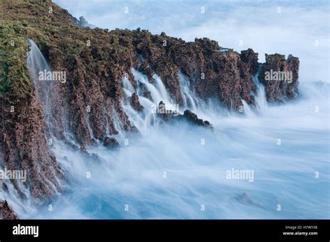 Water Cascading Down Cliffs Into Ocean Christmas Island National Park