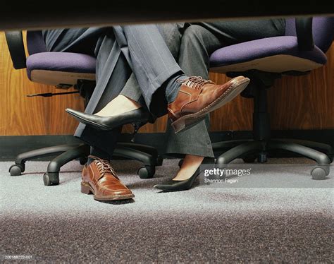 Business Couple Crossing Legs Under Table Low Section Photo Getty Images