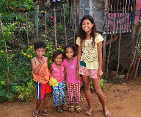 Happy Philippine Children Standing By Their Home