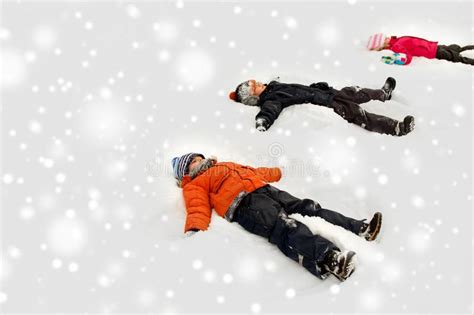 Happy Little Kids Making Snow Angels In Winter Stock Photo Image Of