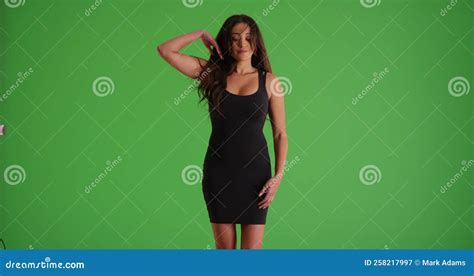Portrait Of Latina Female In Tight Black Dress Dancing Sensually On