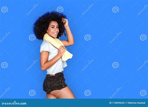 Freestyle Mulatto Girl Walking Isolated On Blue With Towel Around Neck
