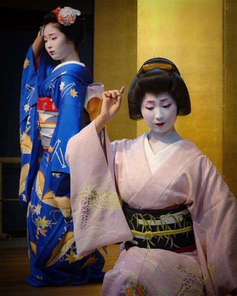 two geisha women dressed in traditional japanese clothing