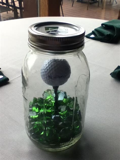 Centering their retirement party on something they are looking forward to is fun and optimistic. Easy and classy golf centerpiece … | Golf centerpieces, Golf gifts, Golf table decorations