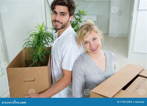 Couple Moving Into New Home And Unpacking Boxes Stock Photo Image Of
