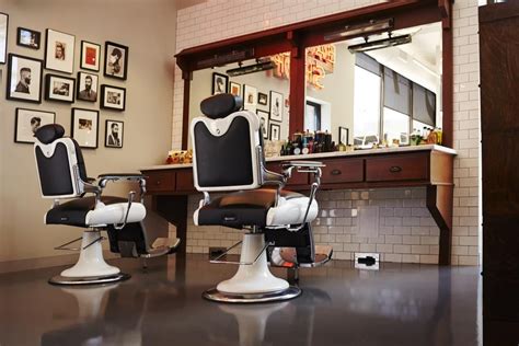 Two Barbering Chairs Oak Stations And American Crew Imagery Set A Distinct Masculine Tone In