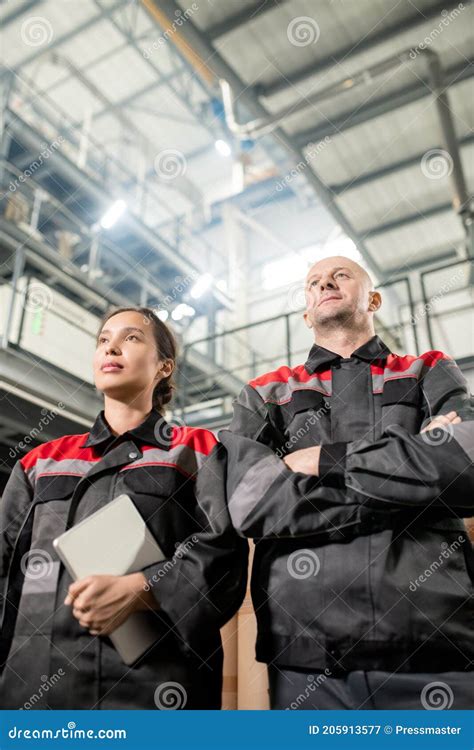 Contemporary Confident Male And Female Workers Of Large Modern Factory