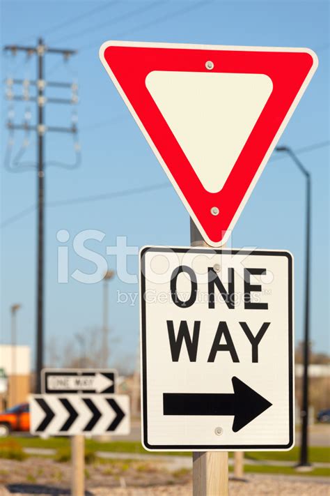 Blank Yield Sign With One Way Signs In Urban Setting Stock Photos