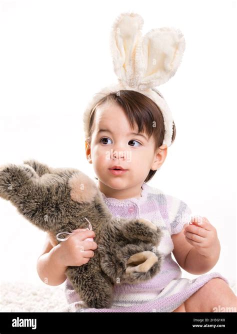 Baby Girl Playing With Toy Rabbit Stock Photo Alamy