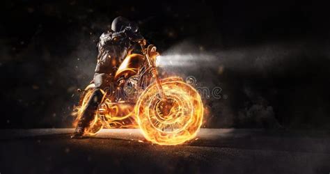 Dark Motorbiker Staying On Burning Motorcycle At Night Stock Photo
