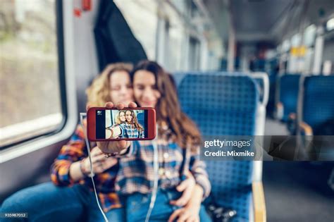 Girlfriends Making Selfies When Travelling In The Open Train Coach High
