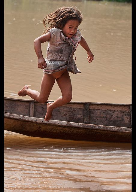 Lanten Girl Jumping Out Of Her Dugout Canoe On The Nam Ha River Luang Nam Tha Laos A Photo