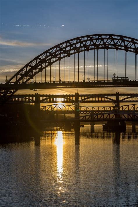 The Tyne Bridge At Sunset Reflecting In The Almost Still River Tyne