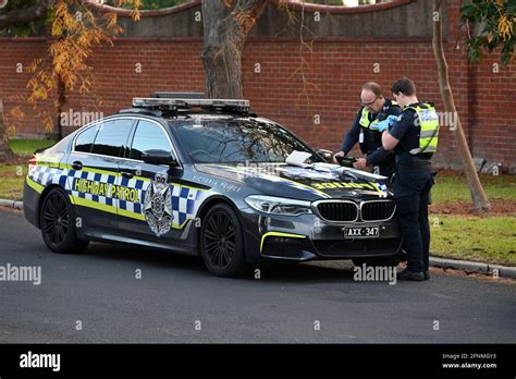 A Victoria Police Highway Patrol Bmw M5 Parked On The Side Of The Road