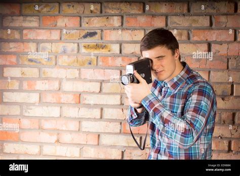Handsome Young Photographer In Casual Long Sleeve Shirt Capturing