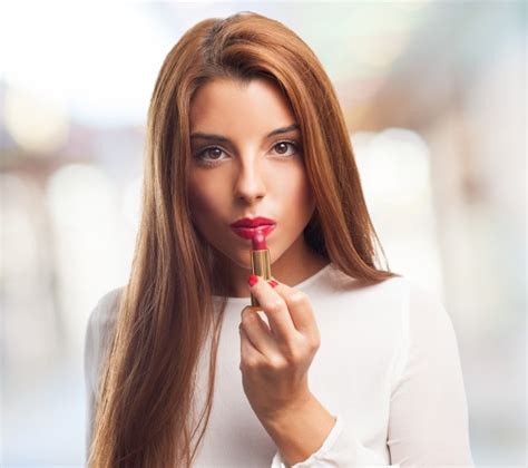 Seductive Female Applying Red Lipstick Photo Free Download