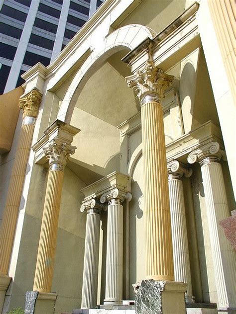 An Arch Between Two Columns In Front Of A Building