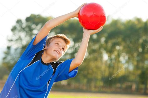 Young Boy Catching Red Ball Outdoors — Stock Photo © Karelnoppe 13654590