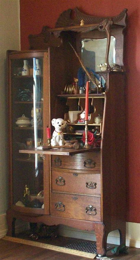 A short curio cabinet display case looks great in any room with a wall mirror above it. Antique Secretary With Curio Cabinet • Patio Ideas