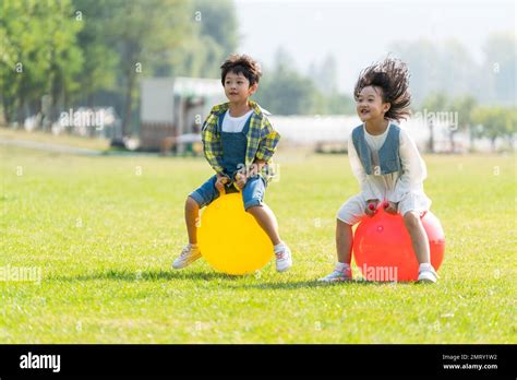 The Two Children Playing Games On The Grass Stock Photo Alamy
