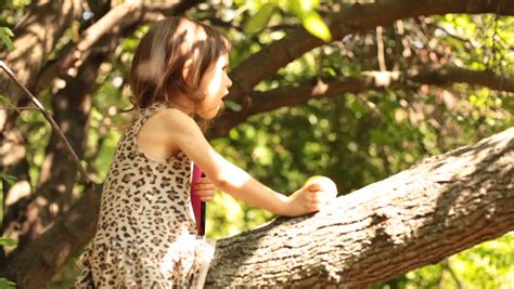 Little Baby Girl Climbing Tree With Pink Notebook Stock Footage Video