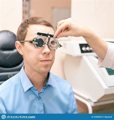 Ophthalmologist Doctor in Exam Optician Laboratory with Male Patient. Men Eye Care Medical ...