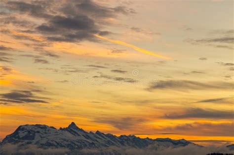 Vibrant Orange Sunset Over Snowy Mountains Stock Photo Image Of Cloud