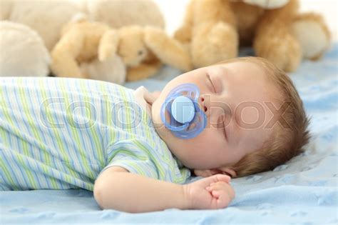 Cute Baby Sleeping With A Pacifier On A Stock Image Colourbox