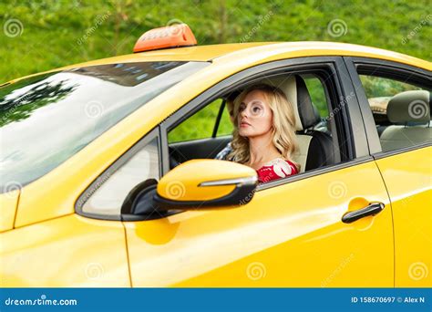 Image Of Female Driver Sitting In Yellow Taxi On Summer Stock Image Image Of Blonde
