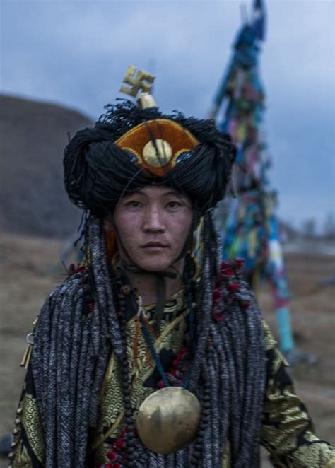 A Woman Dressed In Native Clothing And Headdress
