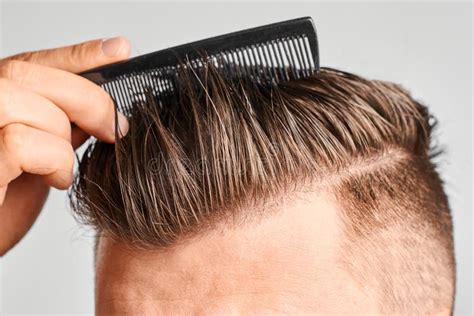 Man Combing His Clean Hair With Plastic Comb Hair Styling At Home