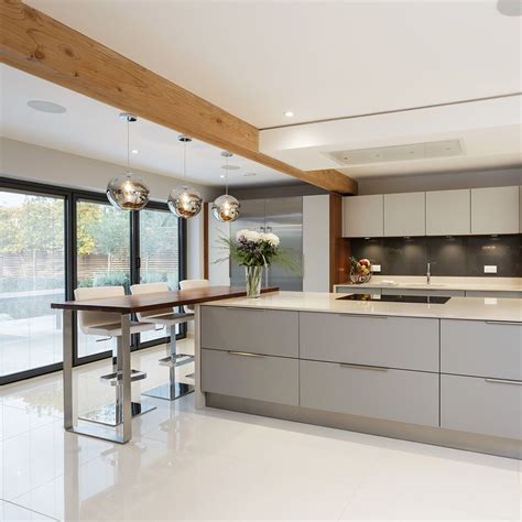 Modern Open Plan Kitchen With Bi Fold Doors White Wall With Timber