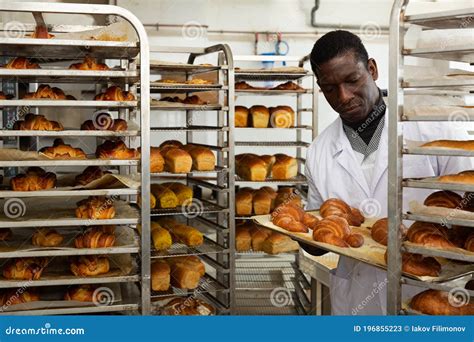 African Baker Placing Tray With Baked Rolls On Trolley Stock Image Image Of Making Cooking