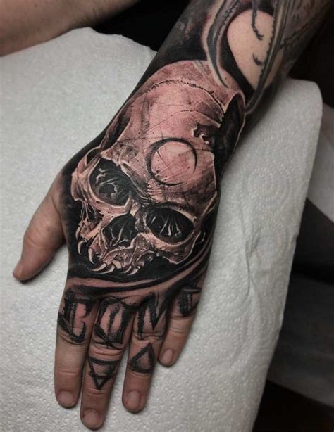 Skull Tattoos Tattoo Insider Hand Tattoos Hand Tattoos For Guys Skull Tattoos