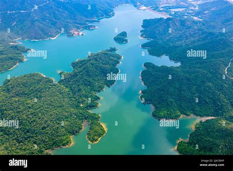 An Aerial View Of A Scenic Forest Lake Surrounded With Trees Stock