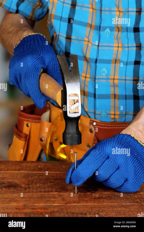 Builders Hands Hammering Nail Into Wood Stock Photo Alamy